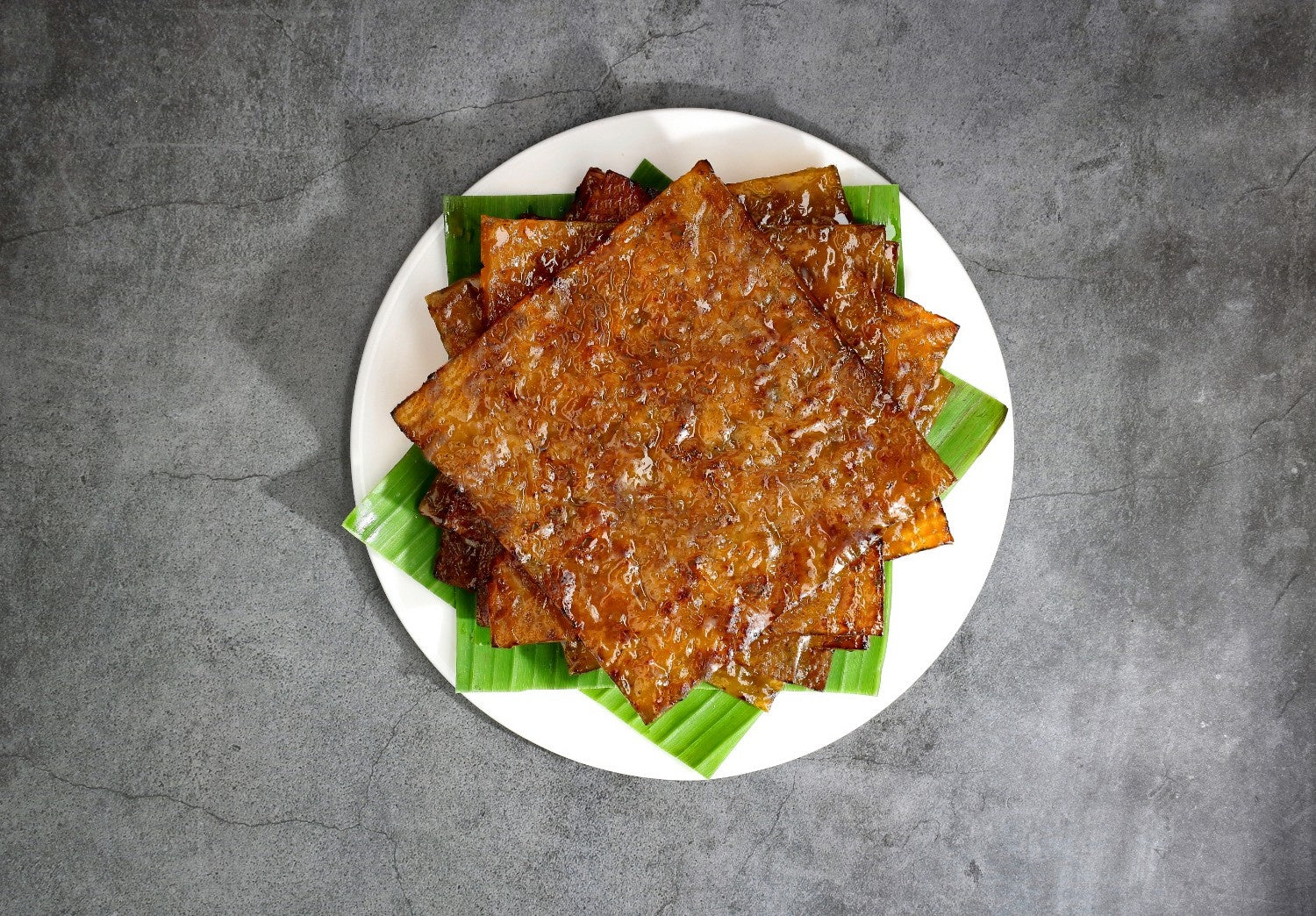Halal Sliced Chicken Ayam Dendeng Bakkwa plated on a Banana Leaf Plate